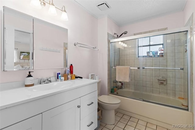 full bathroom featuring tile patterned floors, ornamental molding, bath / shower combo with glass door, vanity, and toilet