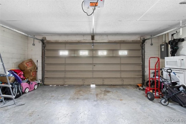 garage with electric panel and a garage door opener