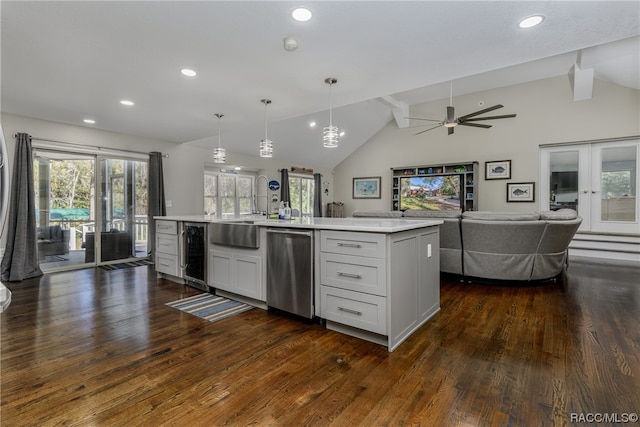 kitchen featuring ceiling fan, pendant lighting, a center island with sink, dishwasher, and dark hardwood / wood-style floors