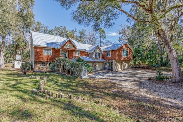 view of front of house with a front yard and a garage