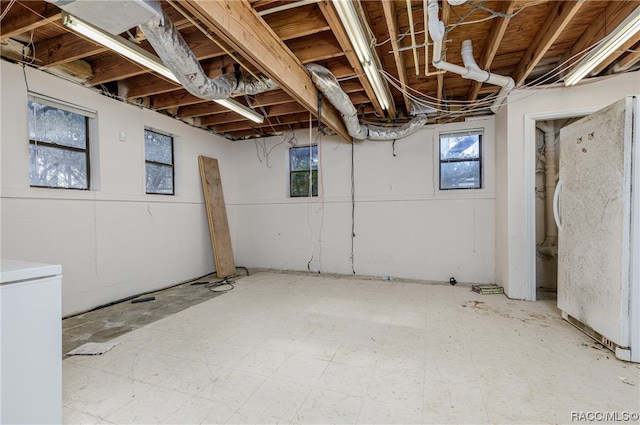 basement featuring white refrigerator