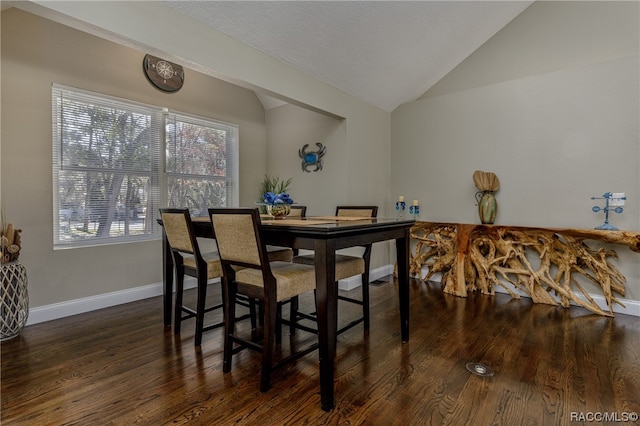 dining area featuring dark hardwood / wood-style floors and lofted ceiling