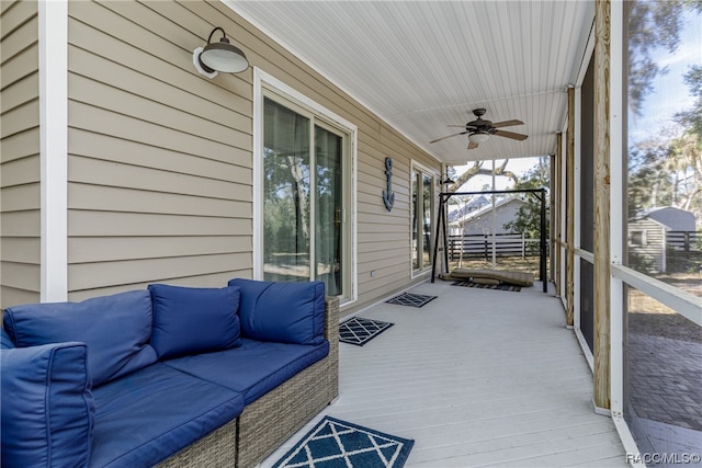 sunroom featuring ceiling fan and wooden ceiling