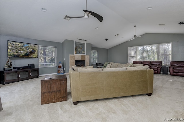 living room featuring plenty of natural light, light colored carpet, and vaulted ceiling