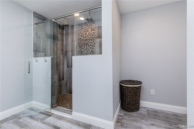 bathroom with a shower with door and wood-type flooring