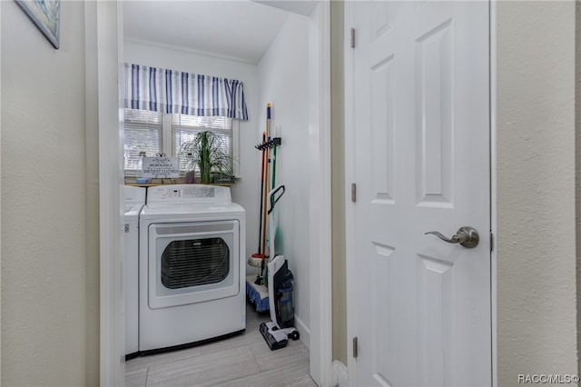 clothes washing area with separate washer and dryer