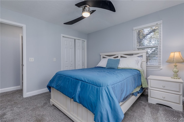 carpeted bedroom with ceiling fan and a closet