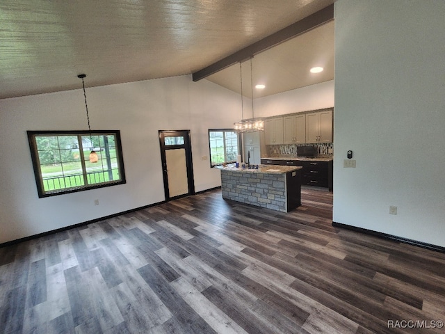 kitchen featuring an island with sink, dark hardwood / wood-style floors, and decorative light fixtures