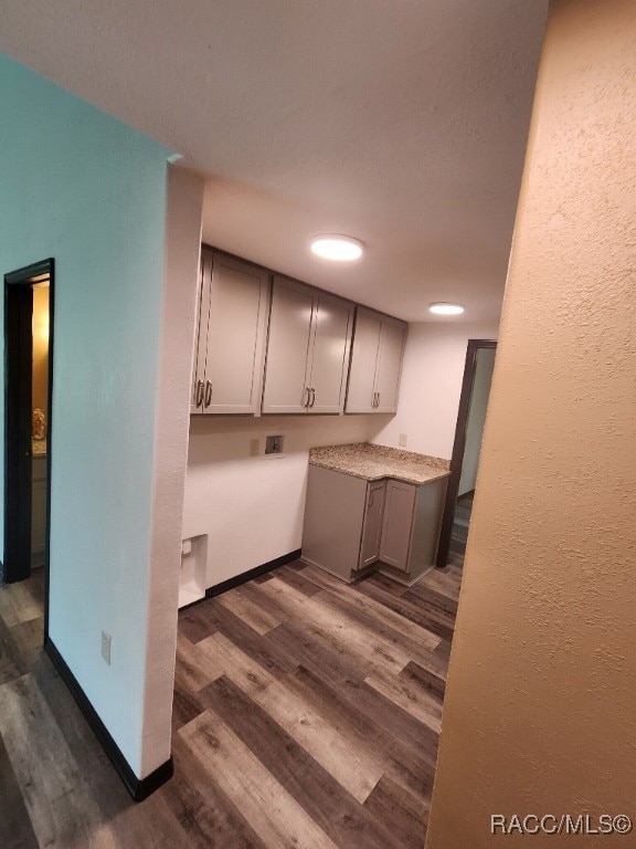 kitchen with dark hardwood / wood-style floors and gray cabinetry