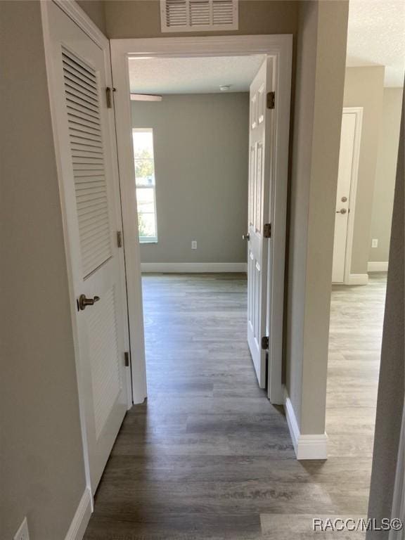 corridor featuring hardwood / wood-style floors