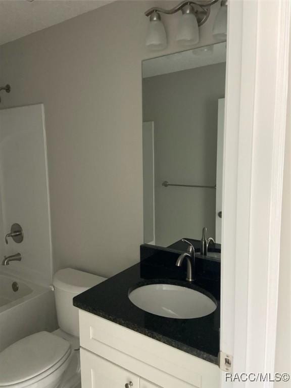 full bathroom with shower / bathtub combination, vanity, and toilet