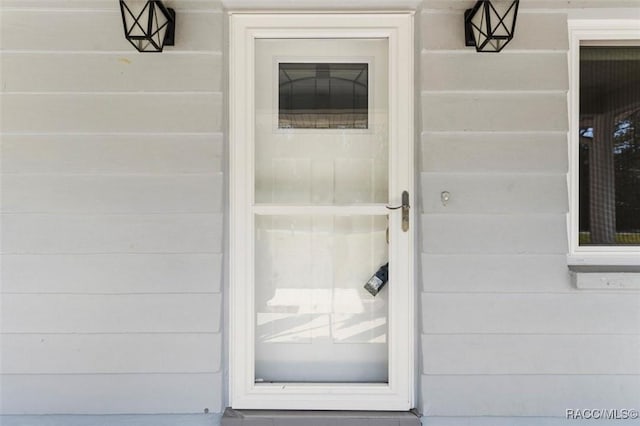 view of exterior entry with a garage