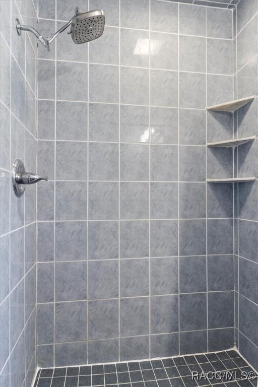 bathroom with tiled shower