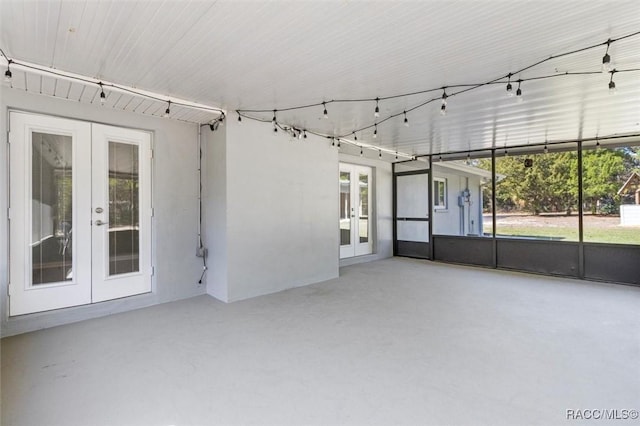 unfurnished sunroom with a healthy amount of sunlight and french doors