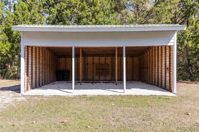 view of pole building with a detached carport and a lawn