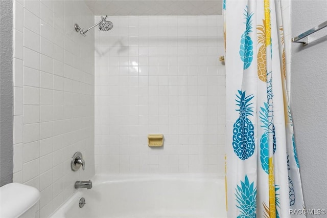 full bathroom featuring toilet, a textured wall, and shower / tub combo with curtain