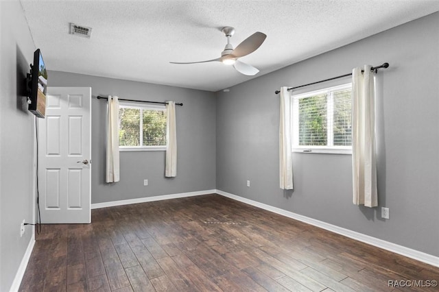 unfurnished room with a textured ceiling, hardwood / wood-style flooring, baseboards, and ceiling fan