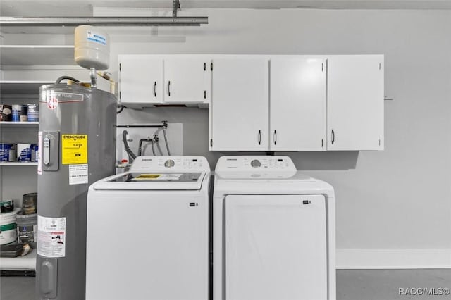 laundry room featuring water heater, cabinet space, and independent washer and dryer