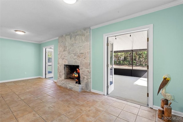 unfurnished living room featuring a stone fireplace, ornamental molding, light tile patterned flooring, and a healthy amount of sunlight