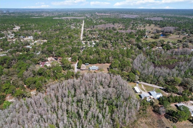 bird's eye view featuring a wooded view