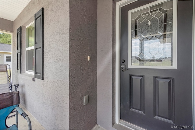 doorway to property featuring covered porch