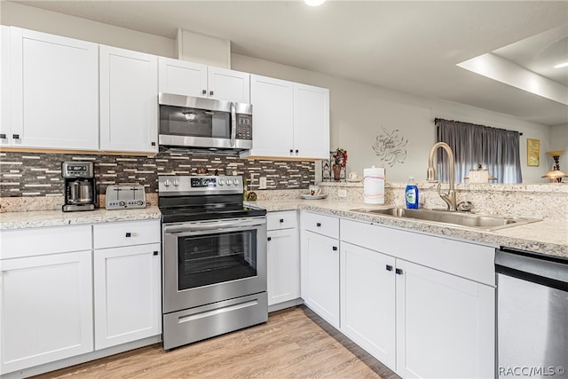 kitchen with white cabinetry, sink, and appliances with stainless steel finishes