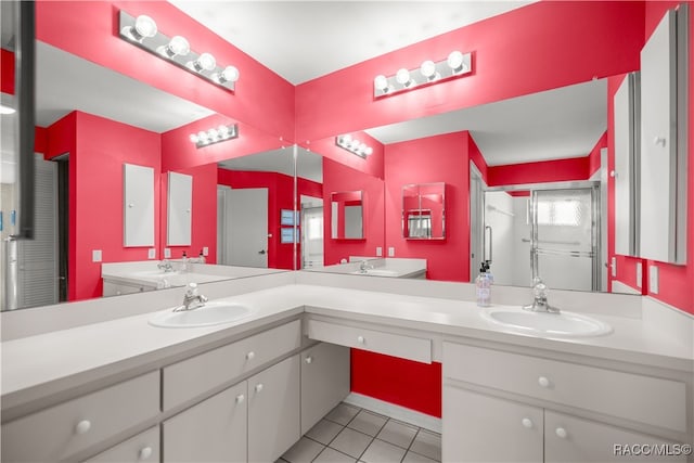 bathroom with tile patterned flooring, vanity, and a shower with shower door