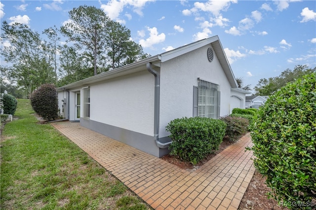 view of property exterior featuring a lawn