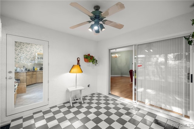 interior space with wood-type flooring and ceiling fan with notable chandelier