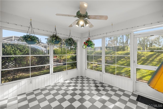 unfurnished sunroom with ceiling fan and a healthy amount of sunlight