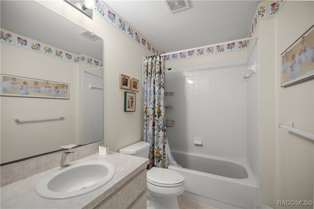 full bathroom featuring tile patterned flooring, shower / bath combination with curtain, a textured ceiling, toilet, and vanity