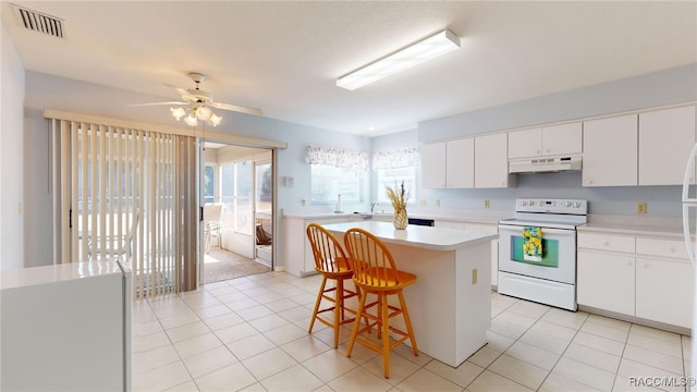 kitchen with white cabinets, white range with electric stovetop, a kitchen island, and a kitchen bar