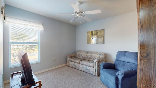 sitting room with light carpet, ceiling fan, and a healthy amount of sunlight