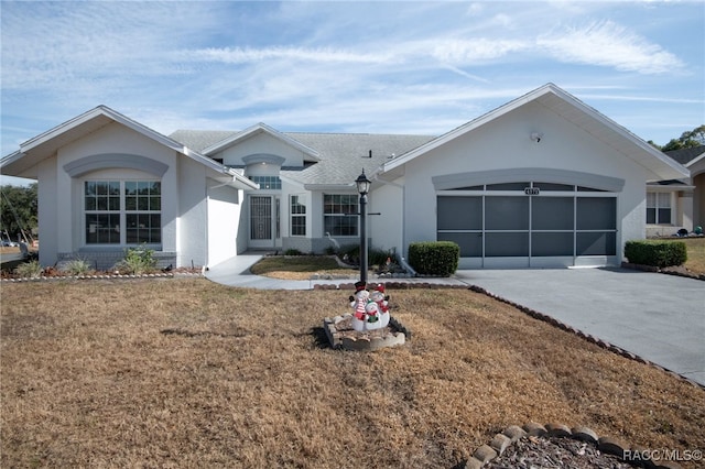 ranch-style house with a garage and a front lawn