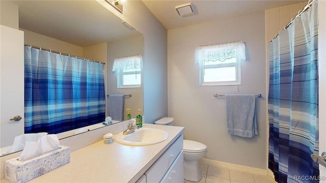 bathroom featuring vanity, tile patterned flooring, and toilet