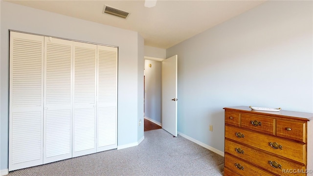 bedroom featuring light colored carpet and a closet