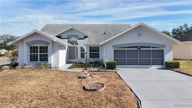 single story home featuring a front lawn and a garage