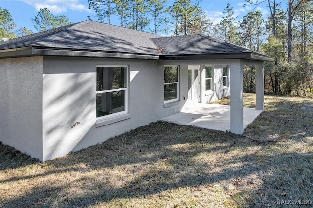 back of house with a yard and a patio area