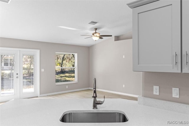 kitchen featuring sink, lofted ceiling, ceiling fan, and gray cabinets