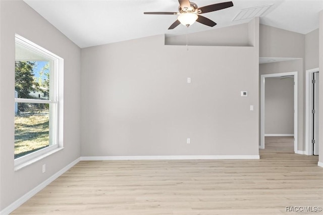 empty room with light hardwood / wood-style floors, ceiling fan, and vaulted ceiling