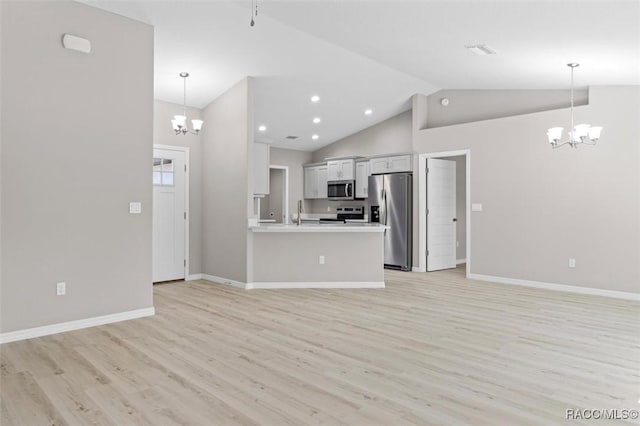 kitchen featuring decorative light fixtures, appliances with stainless steel finishes, and a notable chandelier