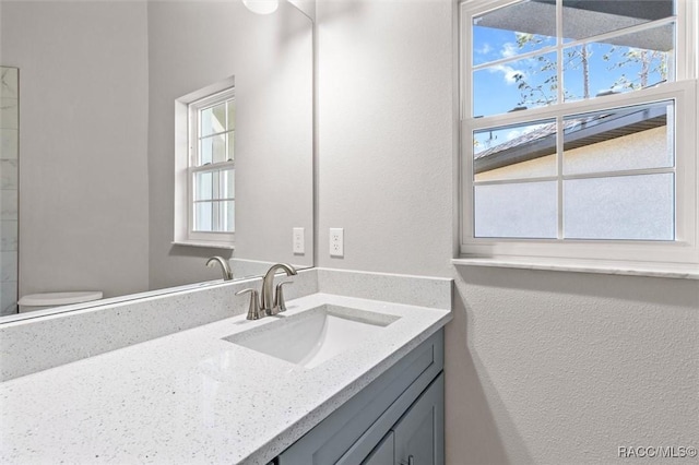 bathroom featuring vanity and toilet