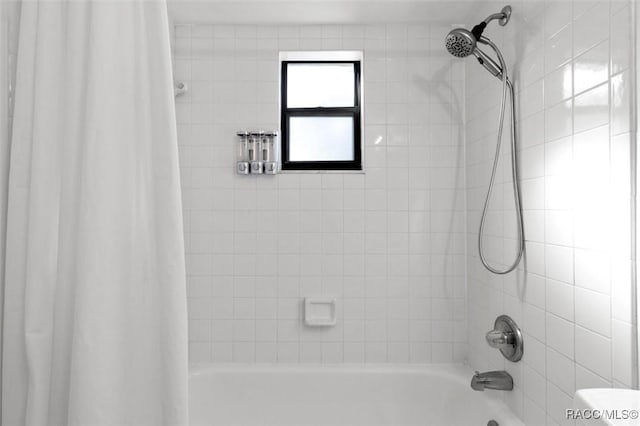 bathroom featuring shower / bathtub combination with curtain