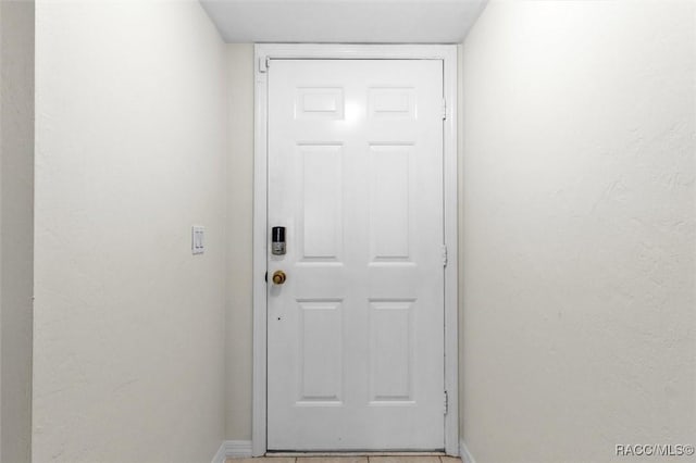 doorway featuring tile patterned flooring