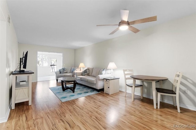 living room featuring ceiling fan and light wood-type flooring