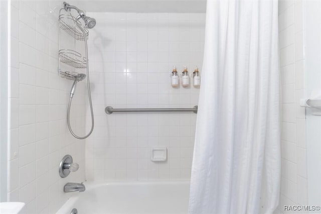 bathroom with shower / bathtub combination with curtain