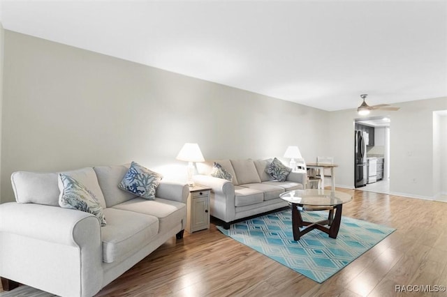 living room with hardwood / wood-style flooring and ceiling fan