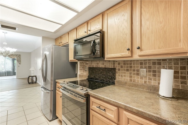 kitchen with light brown cabinets, light tile patterned floors, stainless steel electric range, and a notable chandelier