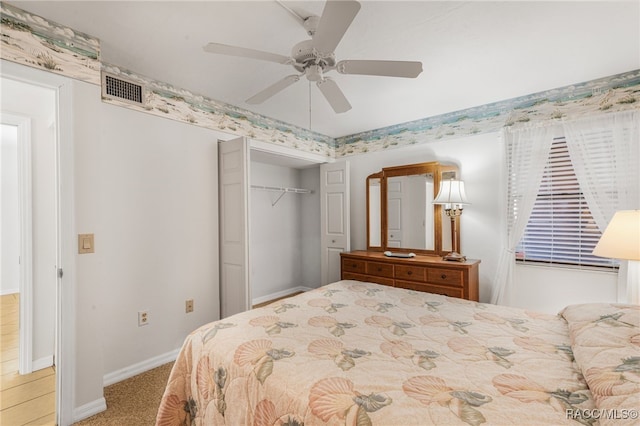 bedroom with ceiling fan, light colored carpet, and a closet