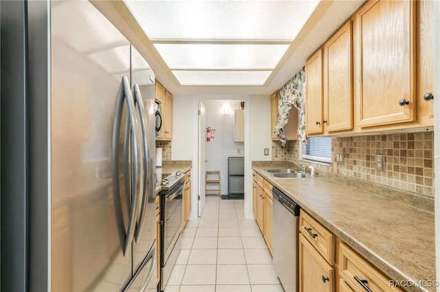 kitchen with tasteful backsplash, sink, light tile patterned floors, and stainless steel appliances